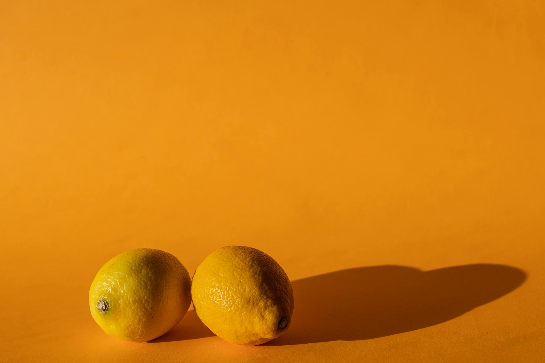 Ripe yellow lemons arranged on a bright background